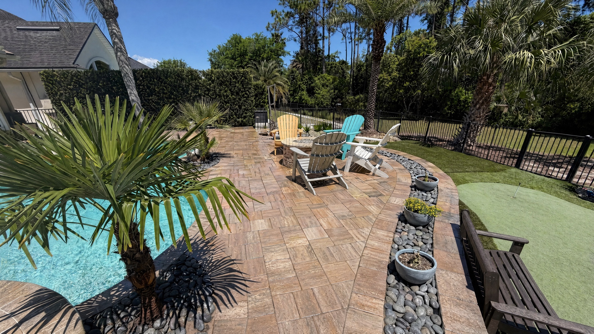 Pool deck after restoration with deep wet-look color and locked joint sand