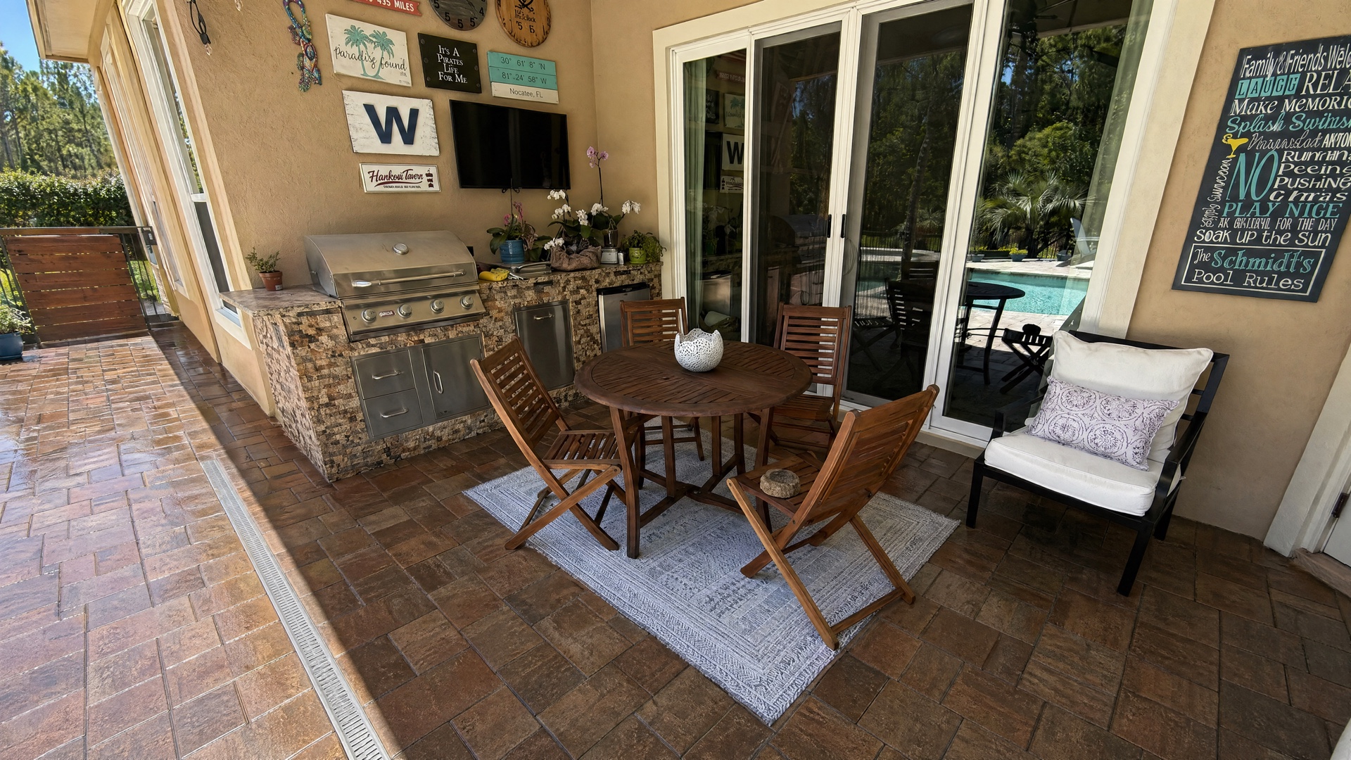 Back patio after Hurricane CAT 5 &mdash; rich sealed cobble, the W plaque, the Schmidts Pool Rules wall